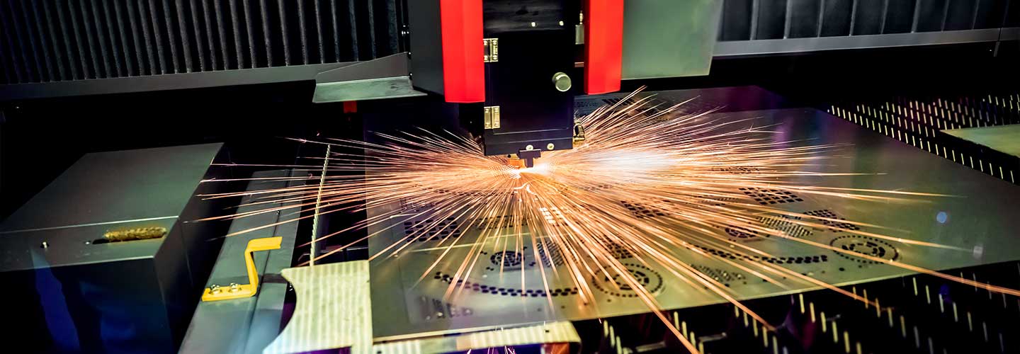 CNC laser cutting metal sheets.